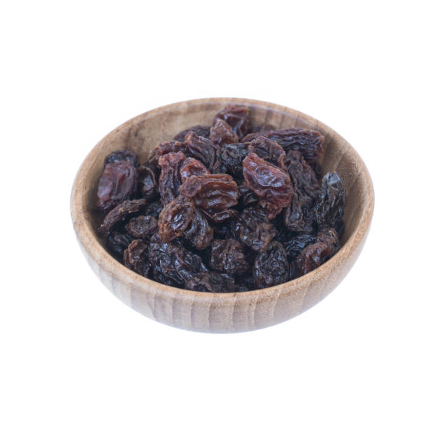 istock Raisins (Sultanas) in bowl wood isolated on white 657733518