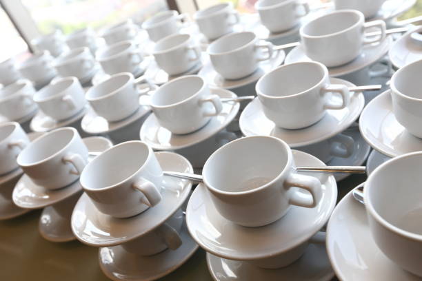 group of empty coffee cups.many rows of white cup for service tea or coffee in breakfast or buffet and seminar event. white cup in catering and cocktail. - banquet table set restaurant imagens e fotografias de stock