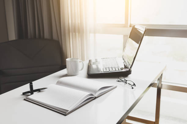 istock laptop, cup and diary on desk in office 657737296