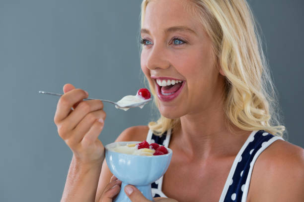 istock Beautiful woman eating fruit salad in bowl 657743416
