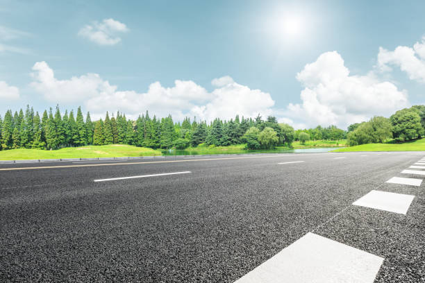 istock Asphalt road and green trees in the blue sky 657743880