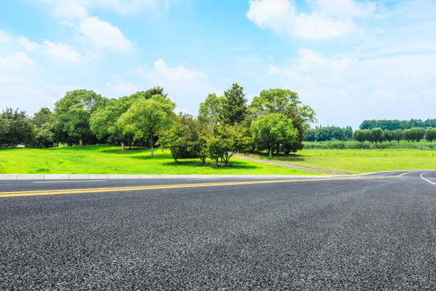 istock Asphalt road and green trees in the blue sky 657746614