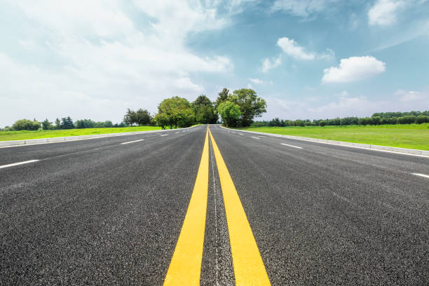 istock Asphalt road and green trees in the blue sky 657747158