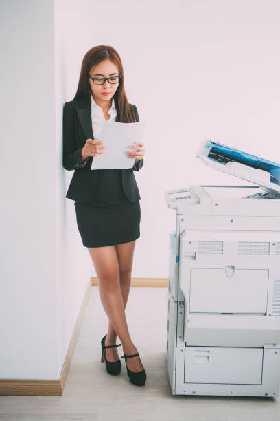 istock Asian Business Woman Studying Document at Copier 657747180