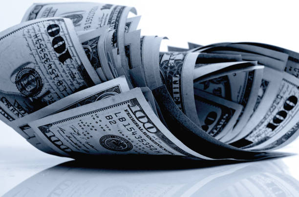 istock US dollars on a plane in black and white. 657750350