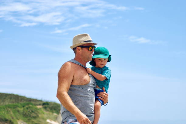 istock Father and Child walking on the Beach. 657751446
