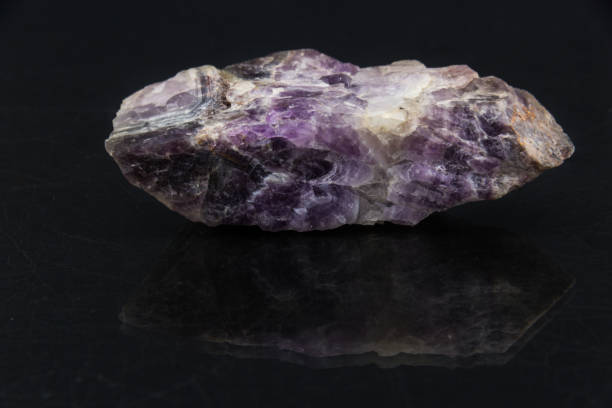 Beautiful semi-precious stone on amethyst druse a black background An attractive amazing mineral amethyst  on a black glossy surface, from a personal collection of semi-precious stones and minerals Gemmary stock pictures, royalty-free photos & images