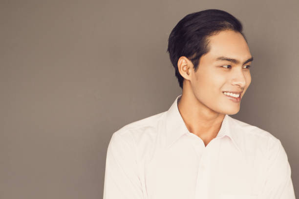 istock Smiling Young Asian Businessman Looking Away 657754278