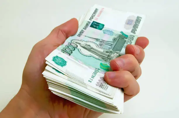 A lot of money Russian rubles in a hand.