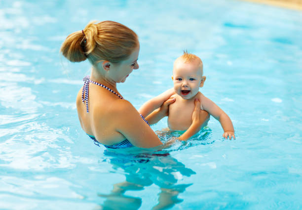 istock Mother and baby swim  in pool 657756206