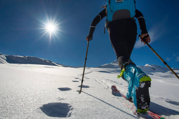 walking with  walking with  ski mountaineering with sealskins in mountains  in mountains - summit cross imagens e fotografias de stock