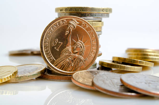 istock US dollar and other coins on a light background. 657756716