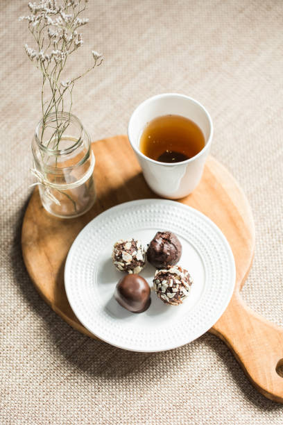 istock Useful sweets with coconut in chocolate and tea 657760658
