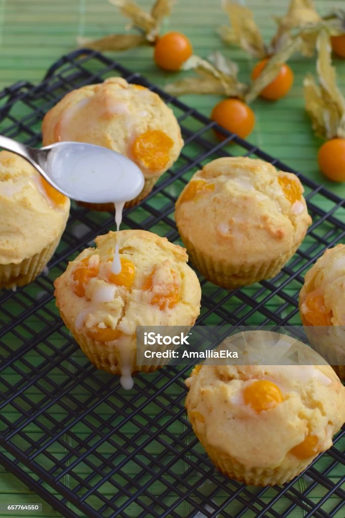 Physalis muffins Physalis muffins with sugar glaze on cooling rack Baked Stock Photo