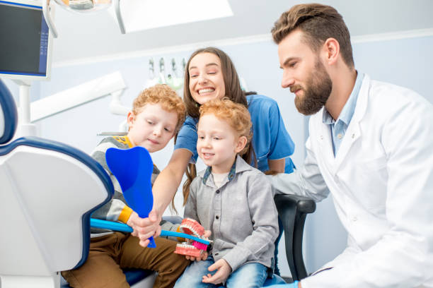 istock Dentists with boys at the dental officee 657764600
