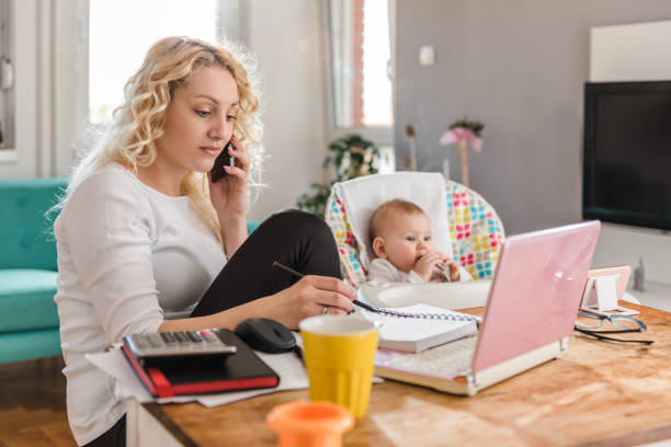 istock Mother talking on smart phone at home office 657767506
