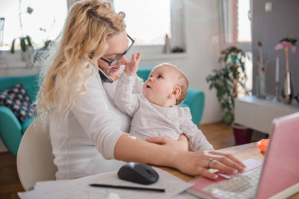 istock Mother talking on smart phone at home office 657768316