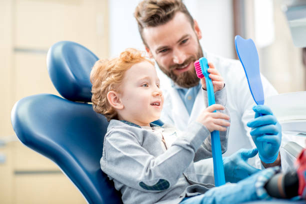 istock Boy with toothbrush at the dental office 657768466