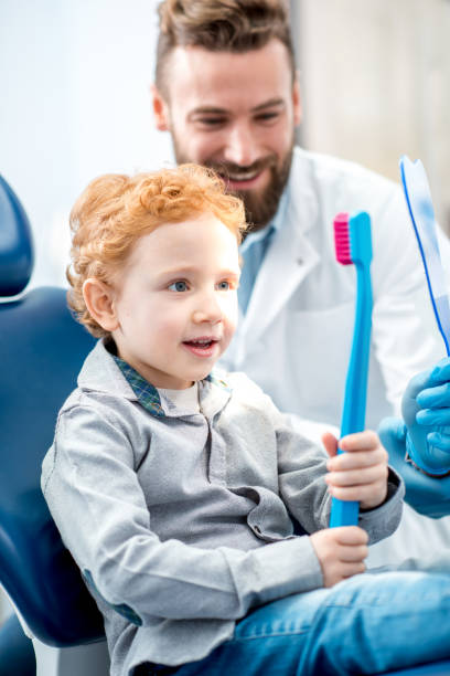istock Boy with toothbrush at the dental office 657768512