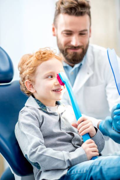 istock Boy with toothbrush at the dental office 657768554