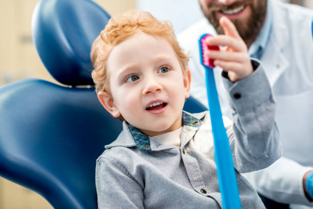 istock Boy with toothbrush at the dental office 657768638