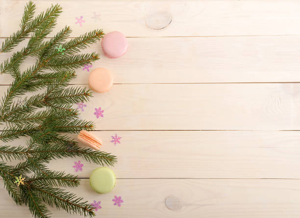 istock cake macarons with Christmas tree branches and snowflakes on wooden background 657769240