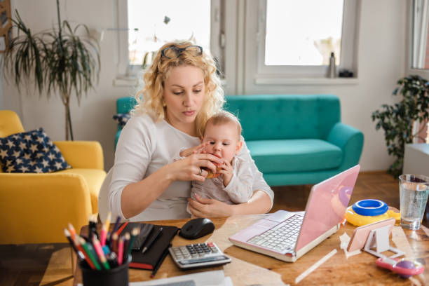 istock Mother feeding baby at home office 657769422