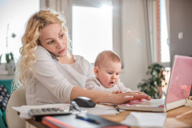 istock Mother talking on smart phone at home office 657771674