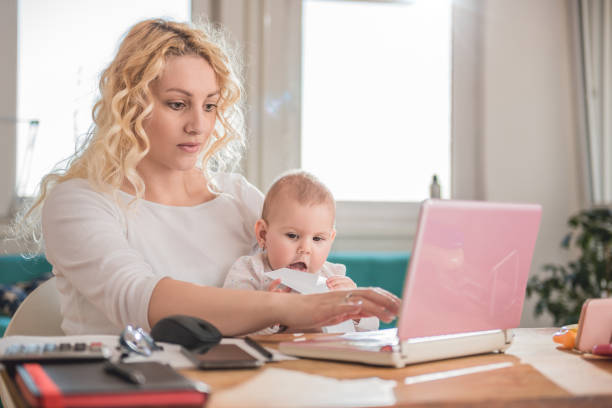 istock Mother working at home office with her baby 657772398