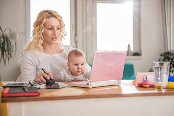 istock Mother working at home office with her baby 657772432
