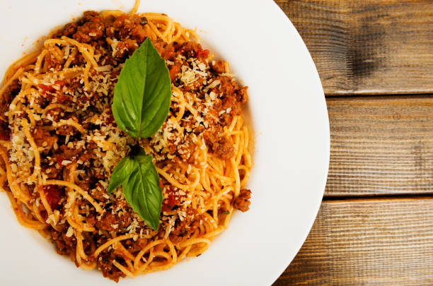 istock Spaghetti bolognese with cheese and basil on a plate 657776272