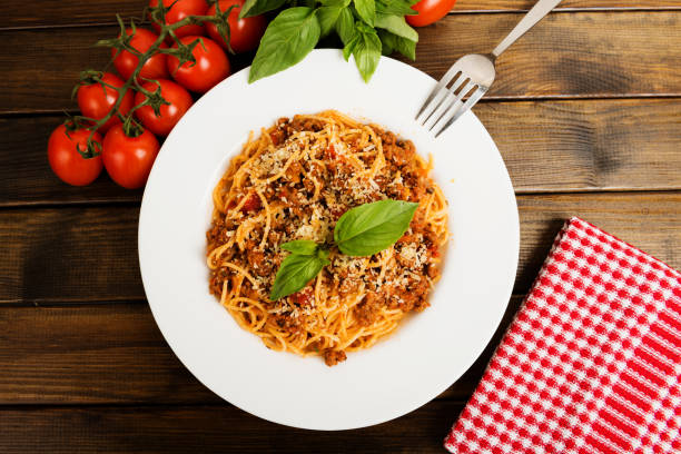 istock Spaghetti bolognese with cheese and basil on a plate 657776276