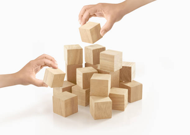 istock Two hands playing wooden box on isolated background. 657779334