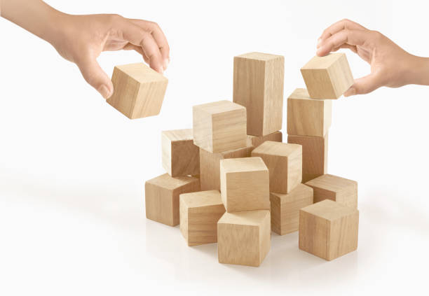 istock Two hands playing wooden box on isolated background. 657779348