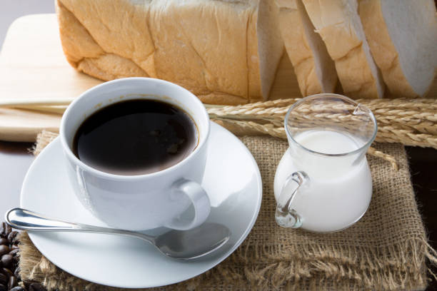 istock Beautiful coffee cup and coffee  beans on table 657780512