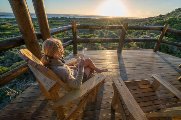 istock Young woman relaxing on terrace at sunset 657791480