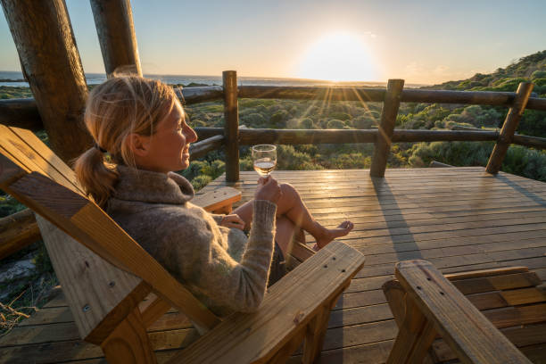 istock Young woman relaxing on terrace at sunset 657791482