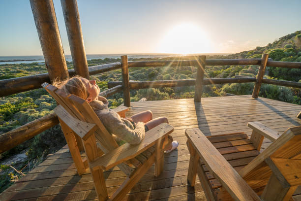 istock Young woman relaxing on terrace at sunset 657791484