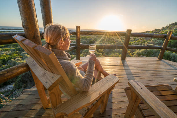 istock Young woman relaxing on terrace at sunset 657791578