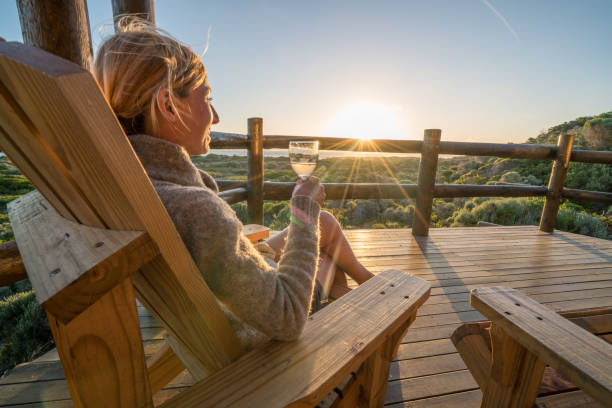 istock Young woman relaxing on terrace at sunset 657791588