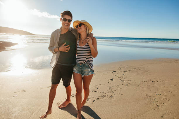 istock Romantic young couple walking on beach 657791802