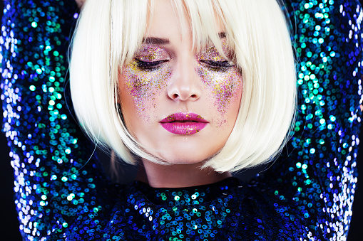 Beautiful Blonde Woman with Party Glitters Makeup