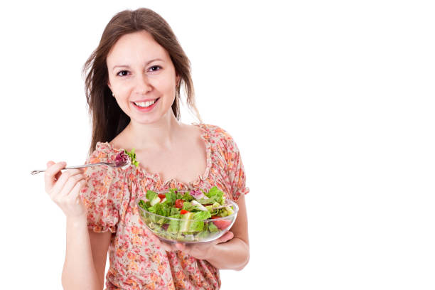 istock Happy young woman eating salad. 657801804