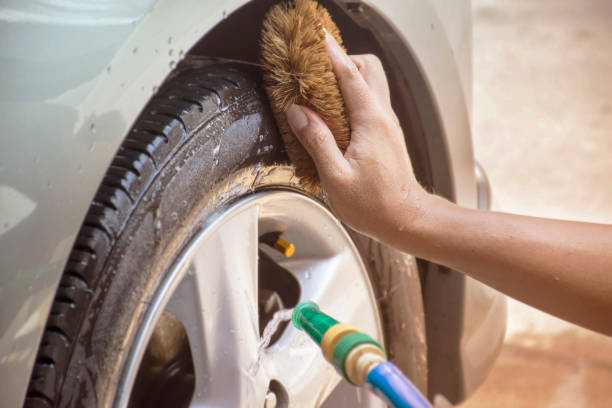 istock Hands and brushes for cleaning wheels car 657812924