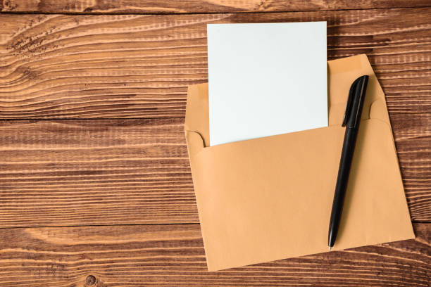 Empty sheet of paper with pen and envelope