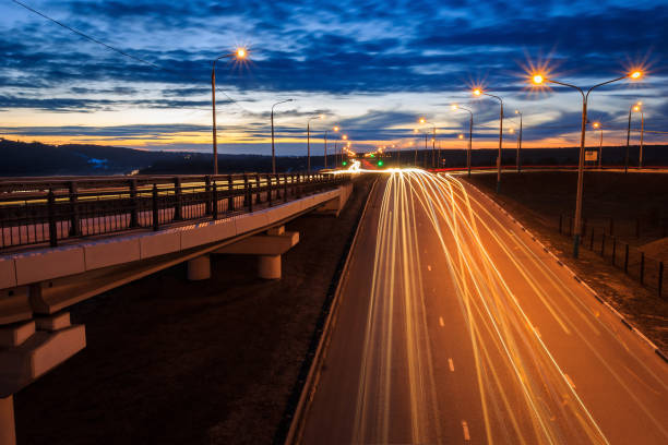 istock Moving car with blur light through twilight city bridge. 657815806