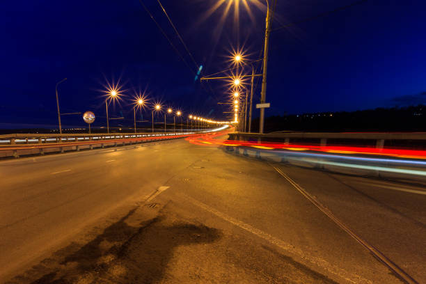 istock Moving car with blur light through twilight city bridge. 657815834