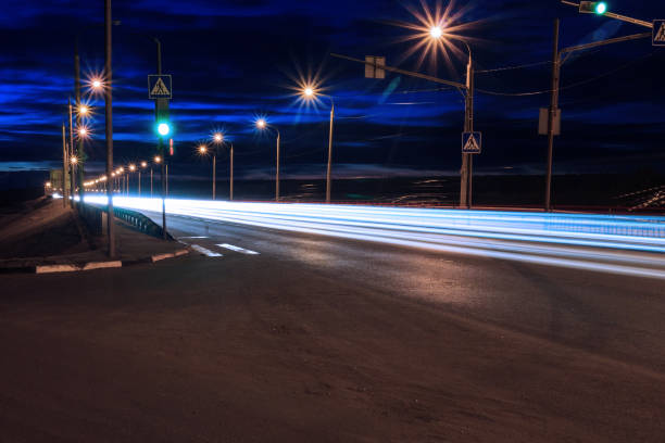 istock Moving car with blur light through twilight city bridge. 657815840