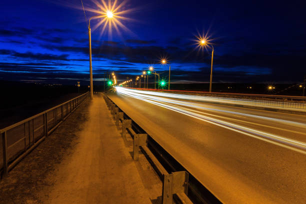 istock Moving car with blur light through twilight city bridge. 657815846