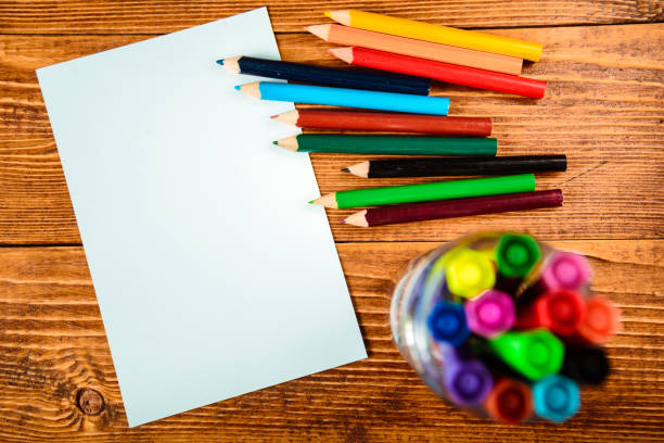 istock Wooden desk table with notebook, color pens 657816010